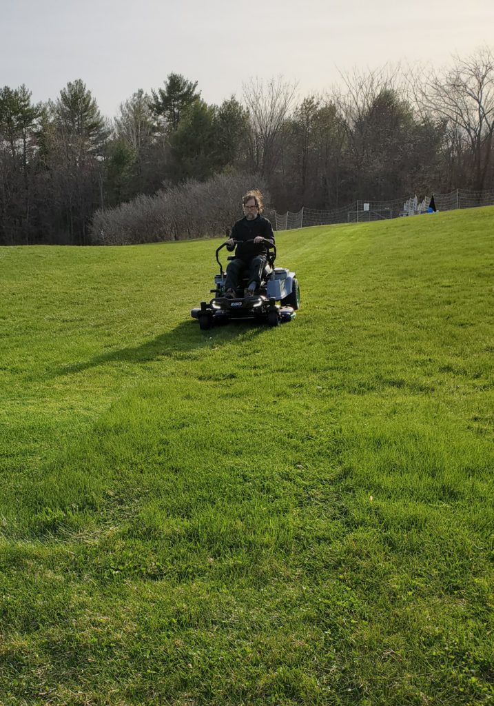 farmer test driving the new electric mower