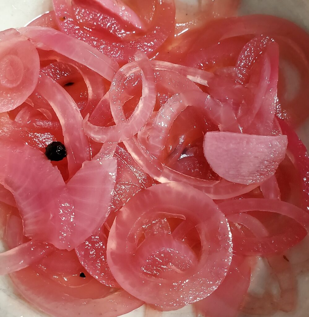 pink slices of pickled red onions